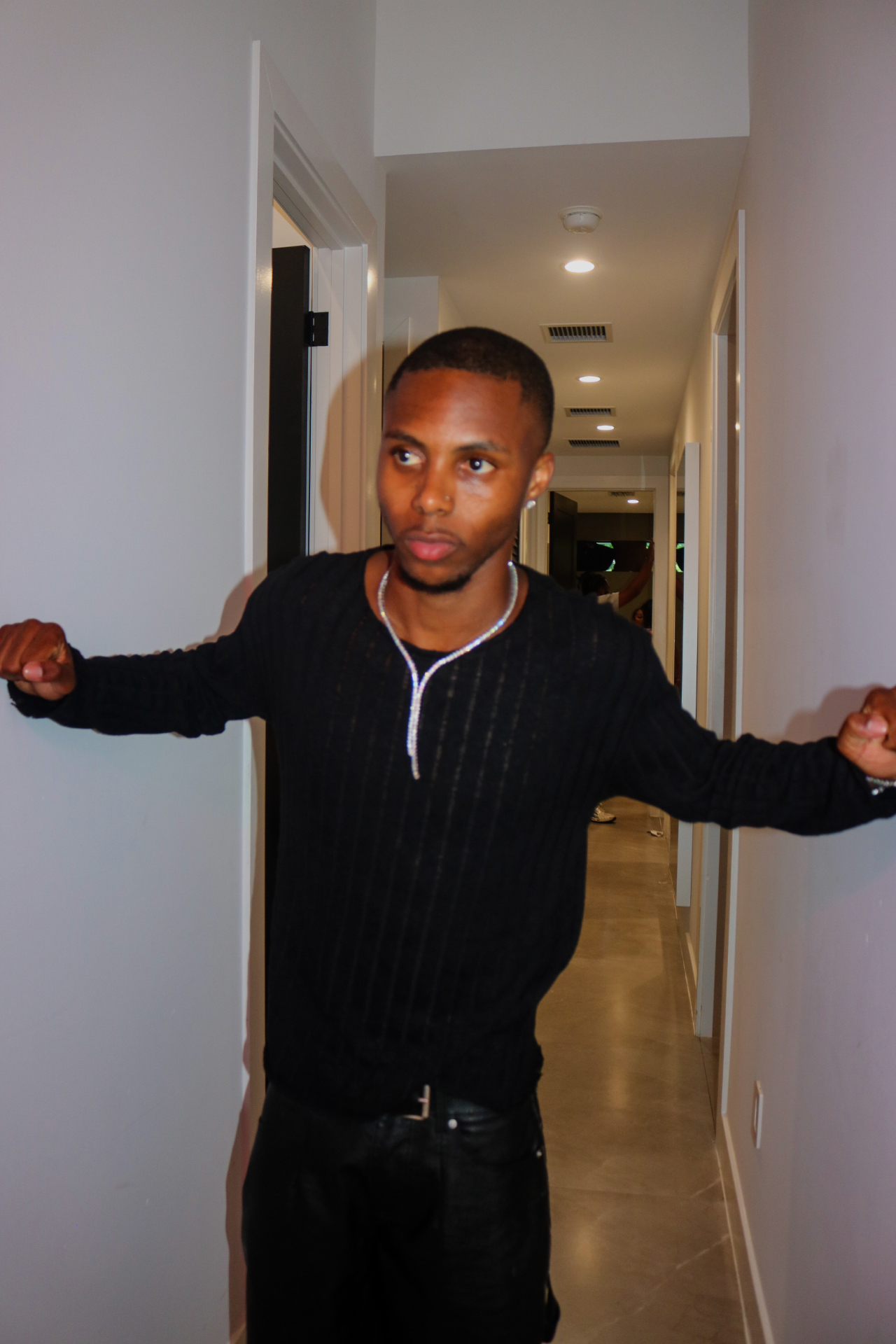 Saint Tailor standing in a hallway